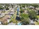 An aerial view showcasing the community, waterfront canal, homes, mature trees and streets of the neighborhood at 279 Maple Ave, Palm Harbor, FL 34684