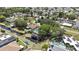 An aerial view showcasing the community, waterfront canal, homes, mature trees and streets of the neighborhood at 279 Maple Ave, Palm Harbor, FL 34684