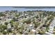 An aerial view showcasing the community, waterfront canal, homes, mature trees and streets of the neighborhood at 279 Maple Ave, Palm Harbor, FL 34684