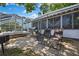 Outdoor patio area with lounge chairs, barbeque and lush landscaping, ideal for relaxing or entertaining at 279 Maple Ave, Palm Harbor, FL 34684