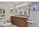 Bathroom with double sink vanity with granite countertop, tile floors and toilet at 279 Maple Ave, Palm Harbor, FL 34684