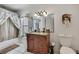 Bathroom featuring a granite countertop, sink, toilet, mirror, and bathtub at 279 Maple Ave, Palm Harbor, FL 34684