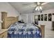 Well-lit primary bedroom showcasing tile floors, white walls, and a comfortable queen-sized bed at 279 Maple Ave, Palm Harbor, FL 34684