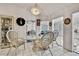 Dining room with glass table, rattan chairs and an elegant chandelier at 279 Maple Ave, Palm Harbor, FL 34684