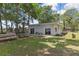 Charming single-story home featuring sliding glass doors and a spacious grassy area perfect for outdoor activities at 279 Maple Ave, Palm Harbor, FL 34684