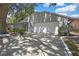 The home features a two-car garage and manicured landscaping, creating an inviting exterior at 279 Maple Ave, Palm Harbor, FL 34684