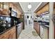 Spacious kitchen with stainless steel appliances, wood cabinets, and light tile floors at 279 Maple Ave, Palm Harbor, FL 34684