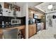 Bright kitchen featuring black countertops, wooden cabinets, and stainless steel appliances at 279 Maple Ave, Palm Harbor, FL 34684