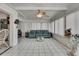 Bright sunroom with tile floors, fan, and large windows for natural light at 279 Maple Ave, Palm Harbor, FL 34684