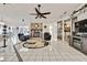 Spacious living room features a stone fireplace, tile floors, and ample natural light for cozy gatherings at 279 Maple Ave, Palm Harbor, FL 34684