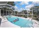 Relaxing screened-in pool and jacuzzi with plenty of space for lounging and entertaining on a sunny day at 279 Maple Ave, Palm Harbor, FL 34684