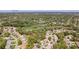 Aerial view of a residential community, golf course, and surrounding lush landscape with the Gulf in the distance at 3013 Appleblossom Trl, Spring Hill, FL 34606