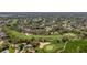 Expansive aerial view of a green golf course surrounded by houses, trees, and landscaping at 3013 Appleblossom Trl, Spring Hill, FL 34606