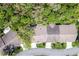 Drone shot of rooftops and surrounding trees at 3013 Appleblossom Trl, Spring Hill, FL 34606