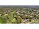 Aerial view of the golf course community with scenic landscaping, complemented by lush green fairways and well-maintained homes at 3013 Appleblossom Trl, Spring Hill, FL 34606