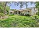 A well-maintained backyard featuring lush green grass, a screened lanai, and a serene outdoor ambiance at 3013 Appleblossom Trl, Spring Hill, FL 34606