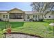 Beautiful backyard with a screened lanai and lush green grass providing a relaxing outdoor space at 3013 Appleblossom Trl, Spring Hill, FL 34606