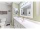 Bright, spacious bathroom with white cabinets, a large mirror, and a tiled floor offering style and functionality at 3013 Appleblossom Trl, Spring Hill, FL 34606