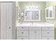 Bright bathroom features white cabinetry, a spacious countertop, and a modern mirror for a clean and elegant design at 3013 Appleblossom Trl, Spring Hill, FL 34606