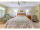 This bedroom features a bed with floral bedding and a ceiling fan at 3013 Appleblossom Trl, Spring Hill, FL 34606