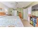 This bedroom features a bed with floral bedding and a ceiling fan and easy access to a private bath and living room at 3013 Appleblossom Trl, Spring Hill, FL 34606