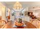 Cozy dining area offers a bay window, unique chandelier and flows into the kitchen and living spaces at 3013 Appleblossom Trl, Spring Hill, FL 34606