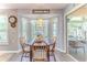 Breakfast nook with chandelier and a bay window, next to sliding glass doors that lead to a patio at 3013 Appleblossom Trl, Spring Hill, FL 34606