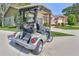 Exterior shot of Yamaha golf cart in driveway with brick home in background at 3013 Appleblossom Trl, Spring Hill, FL 34606