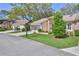 Attractive home with a screened garage, brick details, and a well-kept lawn in a residential neighborhood at 3013 Appleblossom Trl, Spring Hill, FL 34606
