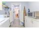 Hallway with saloon doors, cabinets and counters at 3013 Appleblossom Trl, Spring Hill, FL 34606