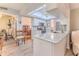 Open kitchen with a skylight, white cabinets, stainless steel appliances, and breakfast bar seating at 3013 Appleblossom Trl, Spring Hill, FL 34606