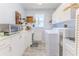 Laundry room with white cabinetry, counter space, utility sink, and washer/dryer hookups at 3013 Appleblossom Trl, Spring Hill, FL 34606