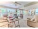 Inviting living room with lots of light and a view into the dining area and kitchen with white cabinets at 3013 Appleblossom Trl, Spring Hill, FL 34606
