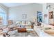 Spacious living room with hardwood floors, comfortable seating, and natural light at 3013 Appleblossom Trl, Spring Hill, FL 34606