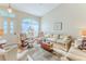 Bright and inviting living room with hardwood floors, a decorative window, and comfortable seating at 3013 Appleblossom Trl, Spring Hill, FL 34606