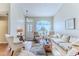 Comfortable living room featuring hardwood floors, a decorative window, and cozy furniture at 3013 Appleblossom Trl, Spring Hill, FL 34606