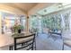Relaxing screened porch with comfortable seating, a ceiling fan, and tranquil views of the lush backyard at 3013 Appleblossom Trl, Spring Hill, FL 34606
