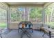 Charming screened porch with comfortable seating, providing a peaceful retreat overlooking the lush backyard at 3013 Appleblossom Trl, Spring Hill, FL 34606