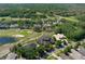 Elevated view of the property showcasing its expansive location within a community alongside a lush golf course at 3026 Wentworth Way, Tarpon Springs, FL 34688