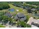 An elevated view of the grand estate, set alongside a golf course and lush landscaping at 3026 Wentworth Way, Tarpon Springs, FL 34688