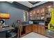 Entertainment area features a wet bar, display cabinets, and bar seating at 3026 Wentworth Way, Tarpon Springs, FL 34688