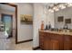Charming powder room with granite countertop, warm wood cabinets, decor, and outdoor views from the adjacent shower at 3026 Wentworth Way, Tarpon Springs, FL 34688