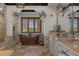 Luxurious bathroom showcasing a copper soaking tub, stone walls, travertine floors, and natural lighting at 3026 Wentworth Way, Tarpon Springs, FL 34688