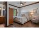 Comfortable bedroom with tufted headboard, hardwood floors, neutral tones, and an ensuite bathroom at 3026 Wentworth Way, Tarpon Springs, FL 34688