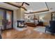 Spacious primary bedroom with a fireplace, four-poster bed, hardwood floors, and access to a private balcony at 3026 Wentworth Way, Tarpon Springs, FL 34688