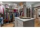 Bright walk-in closet showcasing customized shelving, drawers, and a center island for accessories at 3026 Wentworth Way, Tarpon Springs, FL 34688