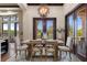 Bright dining area boasting a rustic table, comfortable seating, and natural light streaming through expansive windows at 3026 Wentworth Way, Tarpon Springs, FL 34688