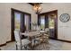 The dining area features a large table and chair set, with patio views and a decorative wall clock at 3026 Wentworth Way, Tarpon Springs, FL 34688