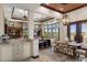 Dining room with custom cabinets, wooden dining table, and many windows at 3026 Wentworth Way, Tarpon Springs, FL 34688