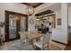 Dining area with backyard views, featuring a rustic dining table set and elegant hanging light fixture at 3026 Wentworth Way, Tarpon Springs, FL 34688